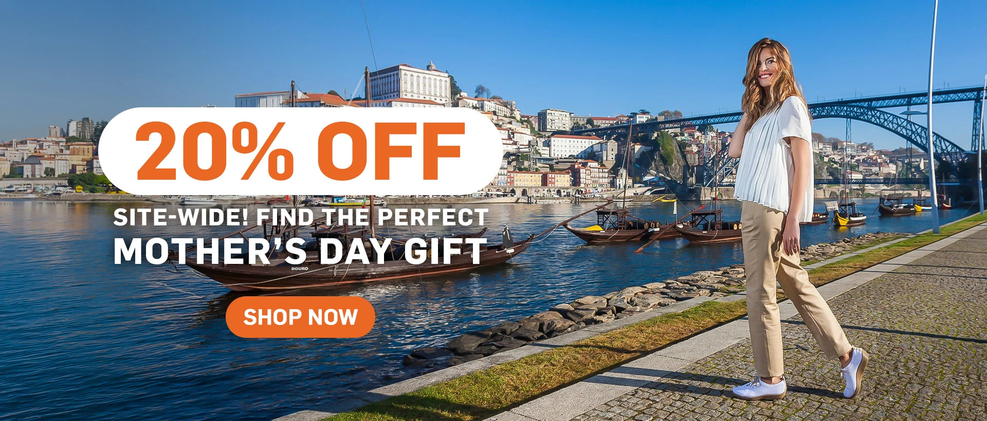 Woman walking by a waterfront with a promotional banner for 20% off Mother's Day gifts.
